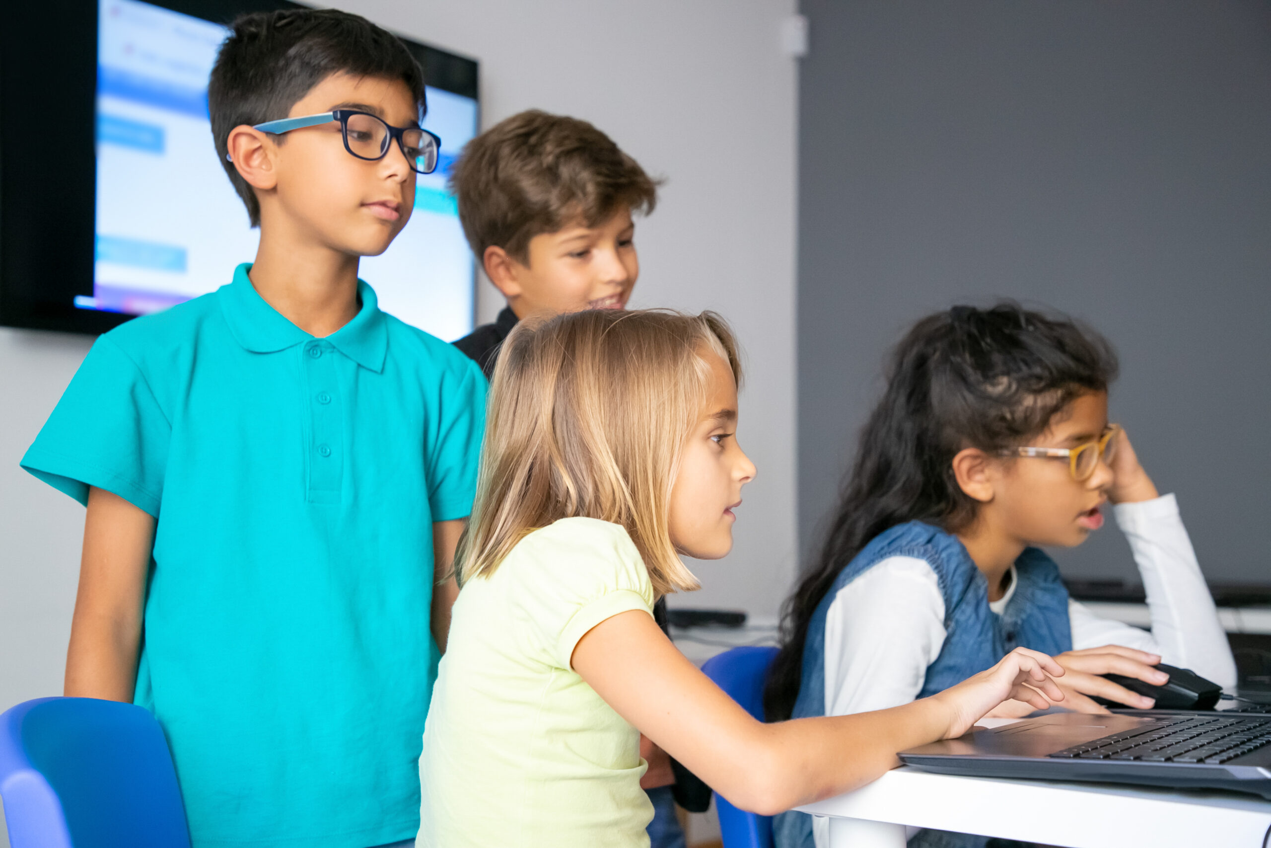 Little girls using laptops, studying at computer school